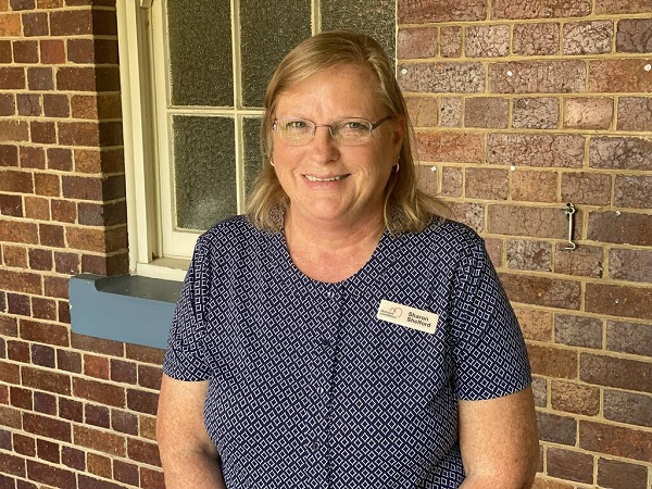 Headshot of Sharon Shelford standing in front of a window in a brick wall at Gympie Hospital