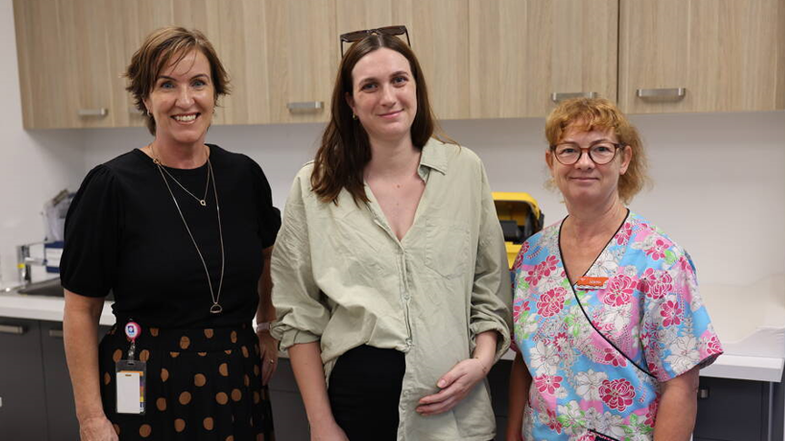 Three women standing in a treatment room