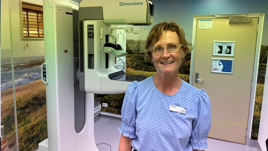 BreastScreen Queensland Sunshine Coast lead investigator Dr Lisa Hammerton stands next to a digital mammography system 